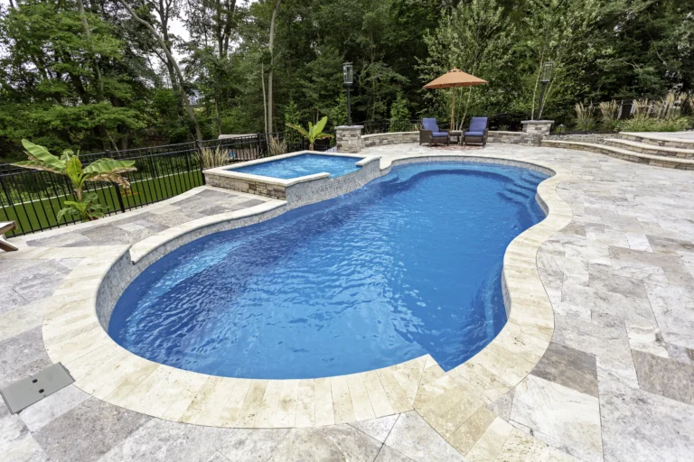 Leisure Pools Riviera in Sapphire Blue with tanning ledge enhancement.