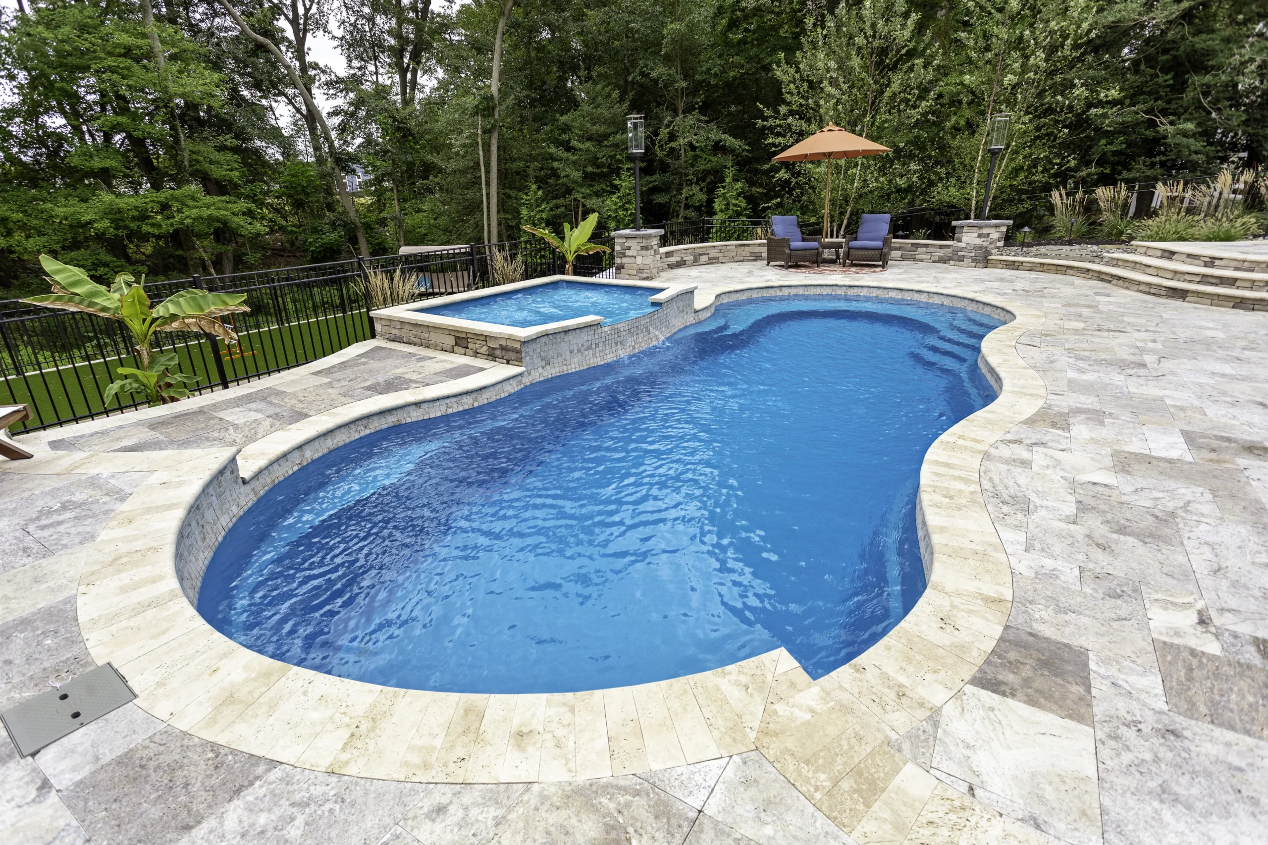 Leisure Pools Riviera in Sapphire Blue with tanning ledge enhancement.