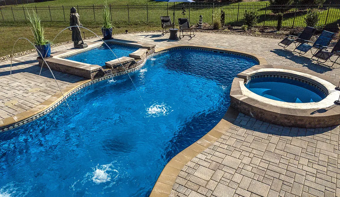 Leisure Pools 40' Mediterranean with spa and tanning ledge enhancements.