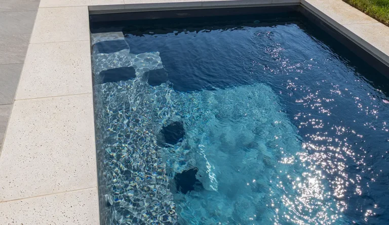 Leisure Pools 26' Harmony model in Graphite Grey detailed shot of steps.