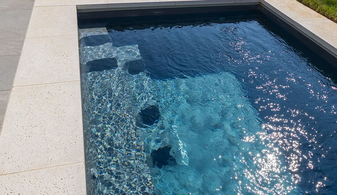 Leisure Pools 26' Harmony model in Graphite Grey detailed shot of steps.