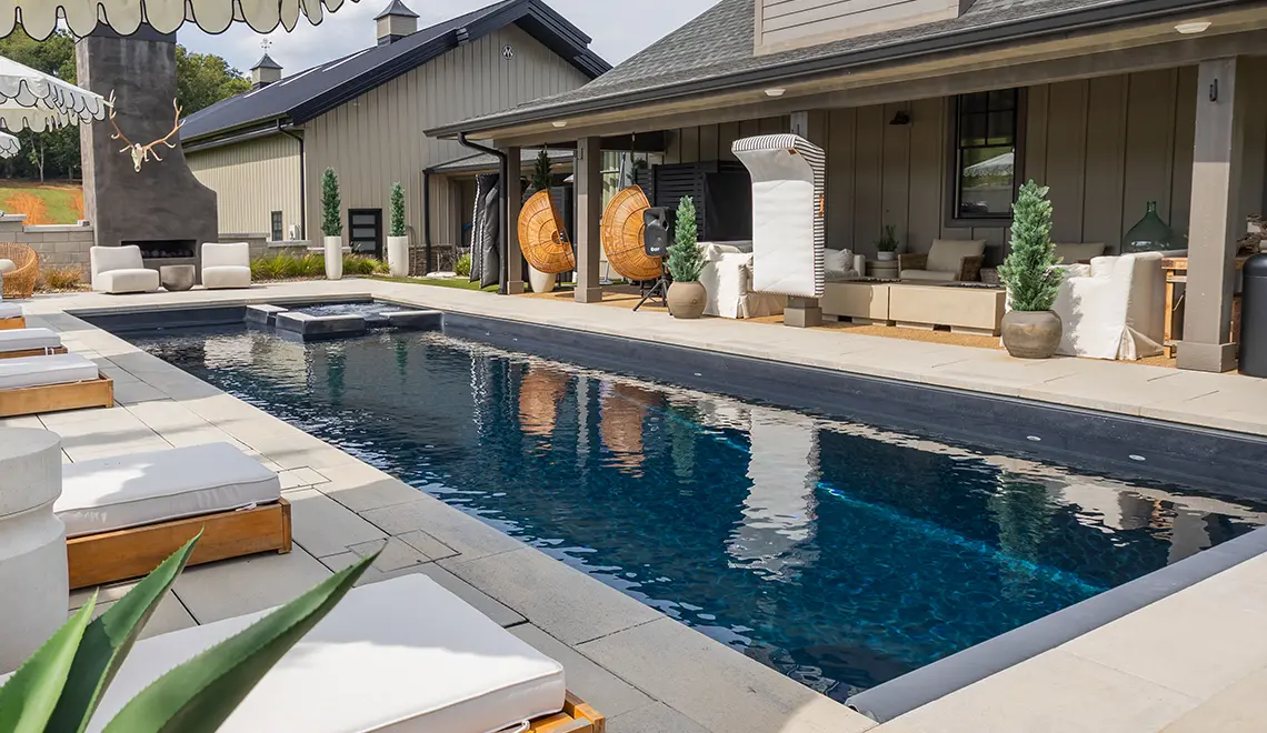 Leisure Pools Icon fiberglass pool in Graphite Grey with integrated splash deck and open swim area