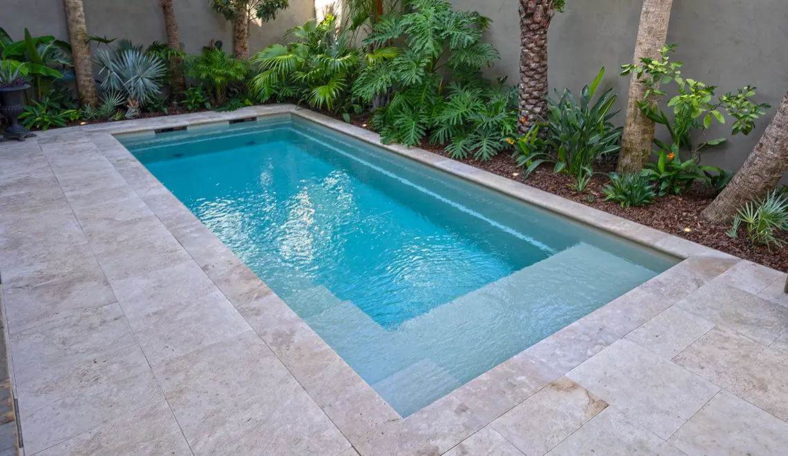 Leisure Pools Precision fiberglass flat bottom swimming pool with built-in splash deck