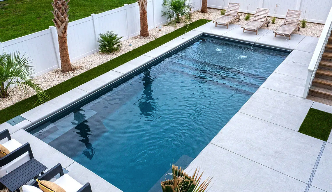 Leisure Pools Summit fiberglass pool with a full width splash pad
