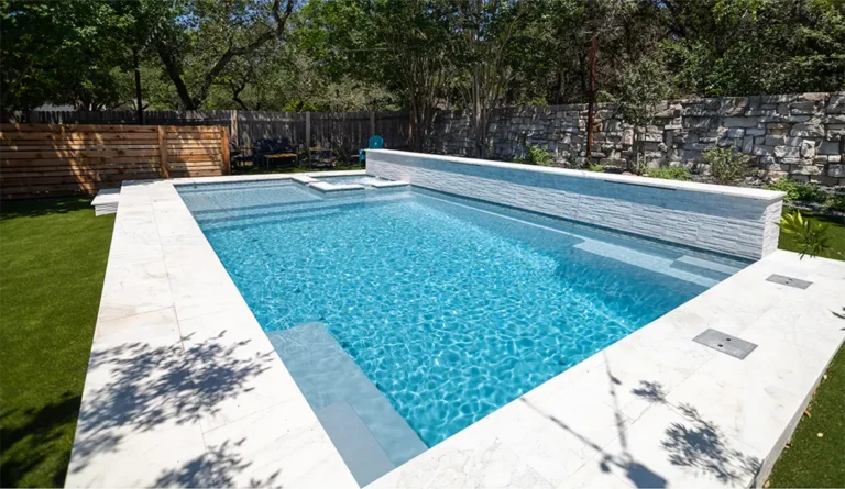 Leisure Pools Ultimate 30-foot fiberglass inground pool with built-in spa and splash deck