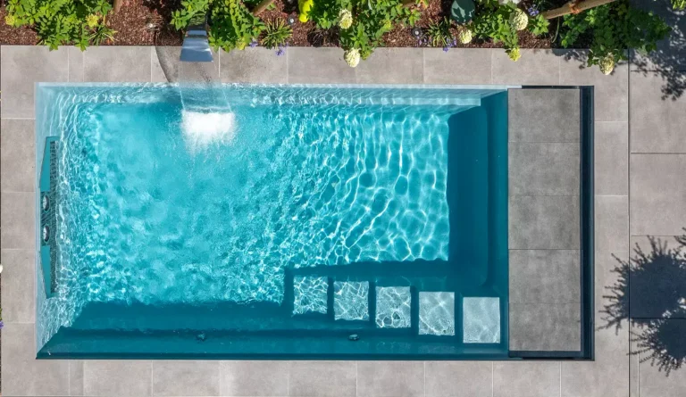 The Linear fiberglass pool unique high water line with cascading water effect and entry steps