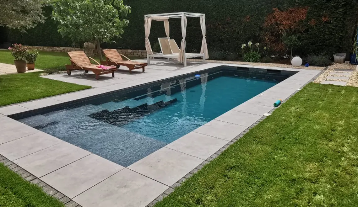 Leisure Pools Precision fiberglass flat bottom swimming pool with built-in splash deck