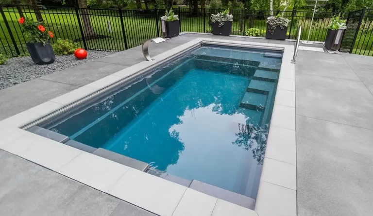 Leisure Pools Precision fiberglass flat bottom swimming pool with built-in splash deck