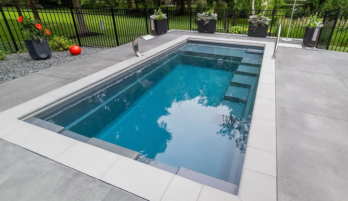 Leisure Pools Precision fiberglass flat bottom swimming pool with built-in splash deck