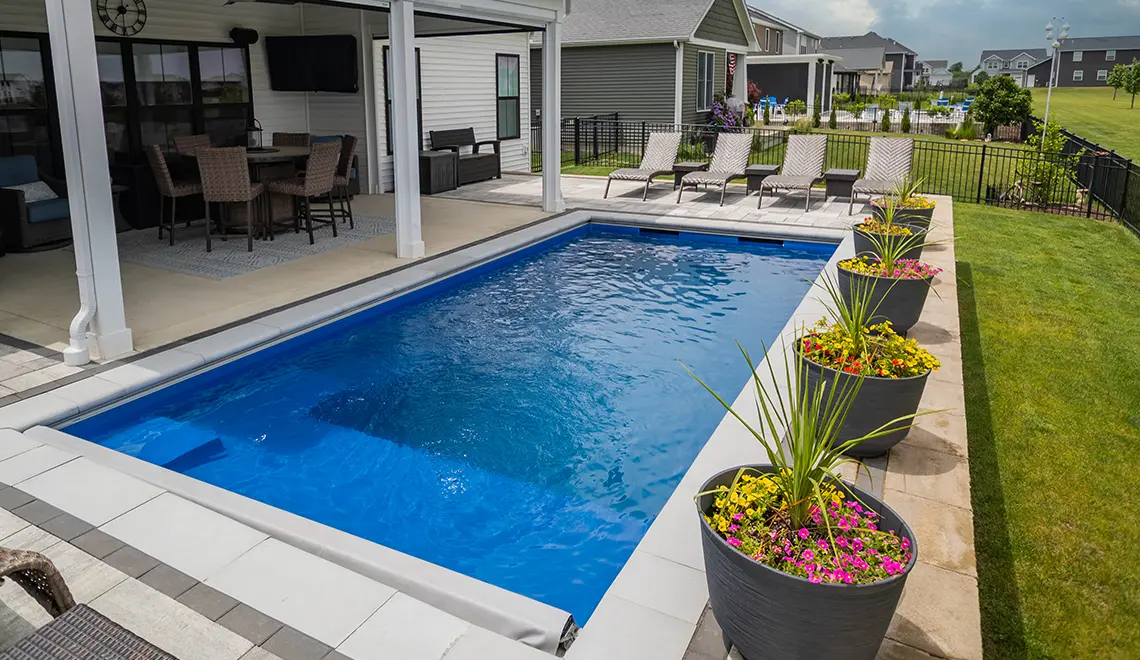 Leisure Pools Precision fiberglass flat bottom swimming pool with built-in splash deck