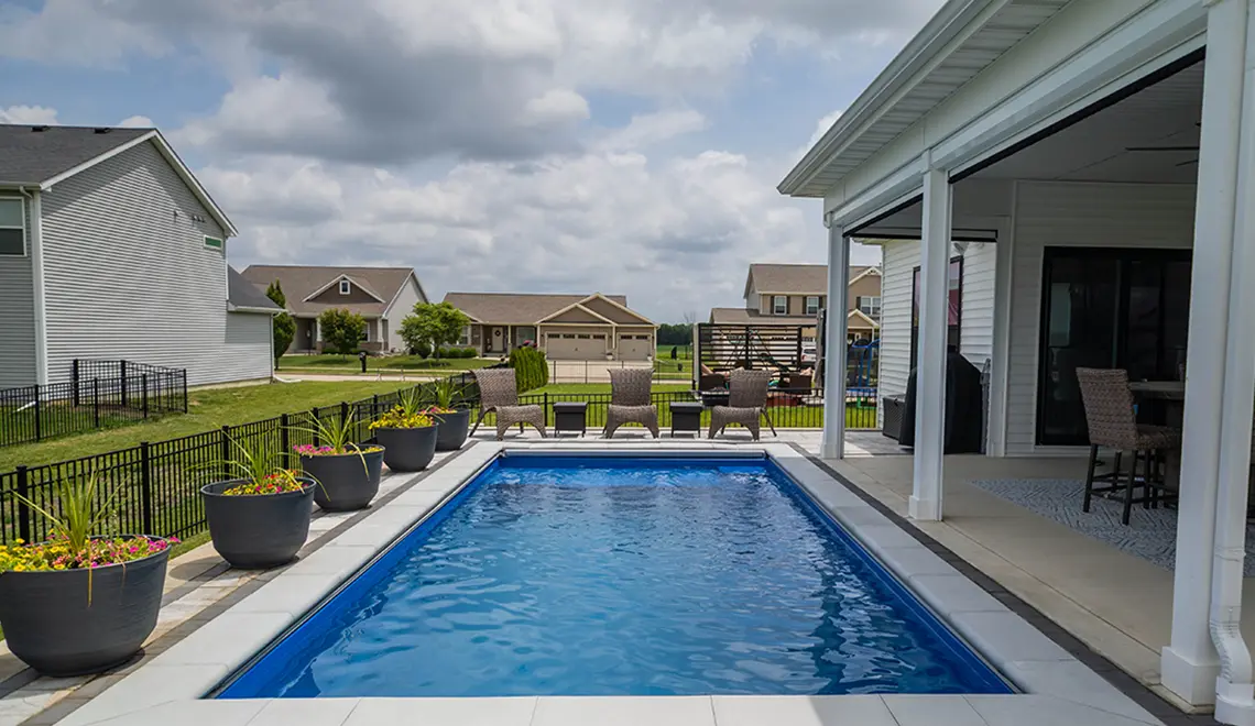 Leisure Pools Precision fiberglass flat bottom swimming pool with built-in splash deck