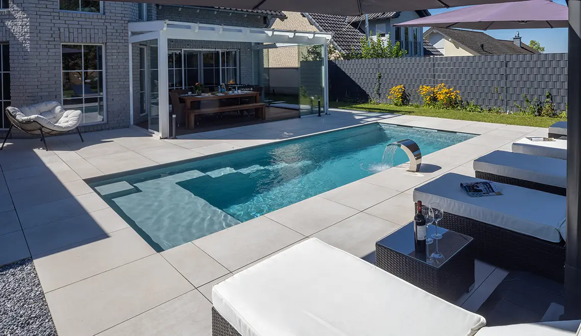 Leisure Pools Precision fiberglass flat bottom swimming pool with built-in splash deck