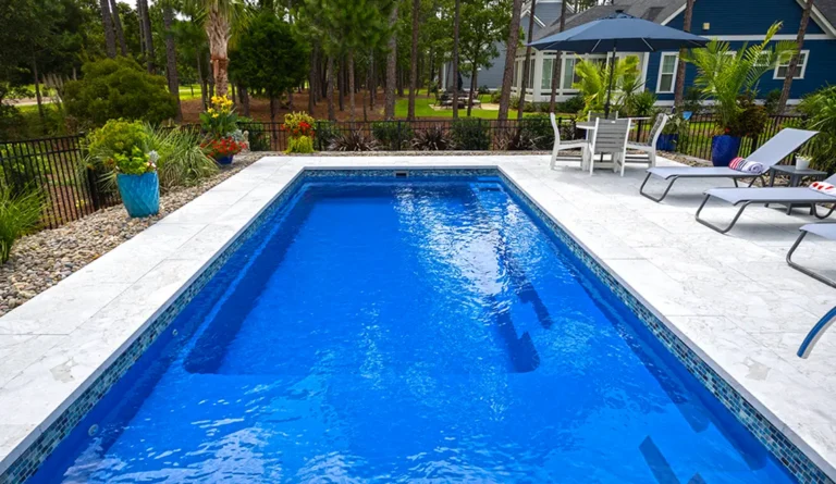 The Reflection fiberglass pool generous splash deck and full length bench seat