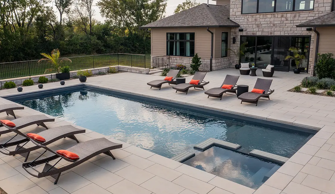 Leisure Pools Ultimate 40-foot fiberglass inground pool with built-in spa and splash deck