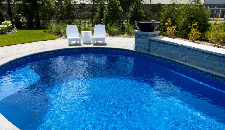 Leisure Pools Allure 40 fiberglass pool with outdoor seating and backyard landscaping
