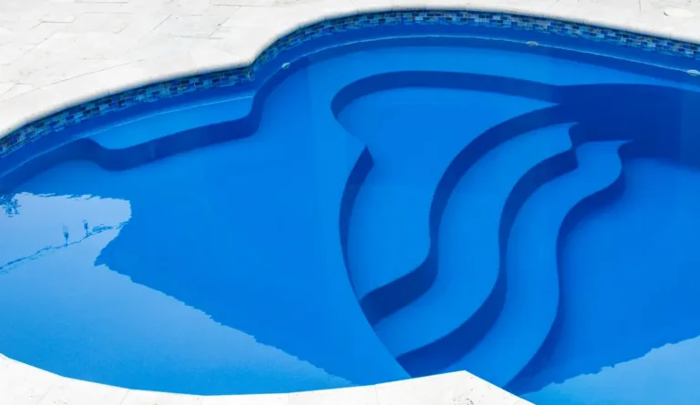 The Eclipse 35 fiberglass pool overhead view showing splash deck and spa nook in Sapphire Blue
