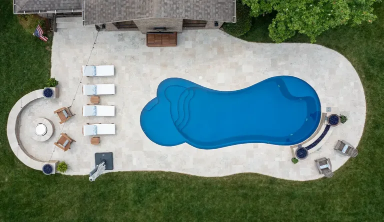 Leisure Pools Eclipse fiberglass pool overhead view showing integrated splash deck in Sapphire Blue