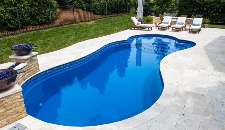 The Eclipse fiberglass pool in Sapphire Blue installed with full patio surround