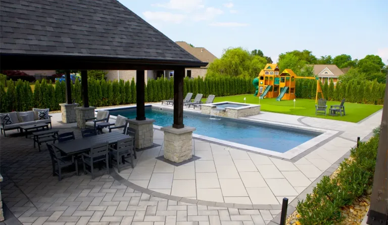 The Wave fiberglass pool with gazebo, pool house, and family backyard setting