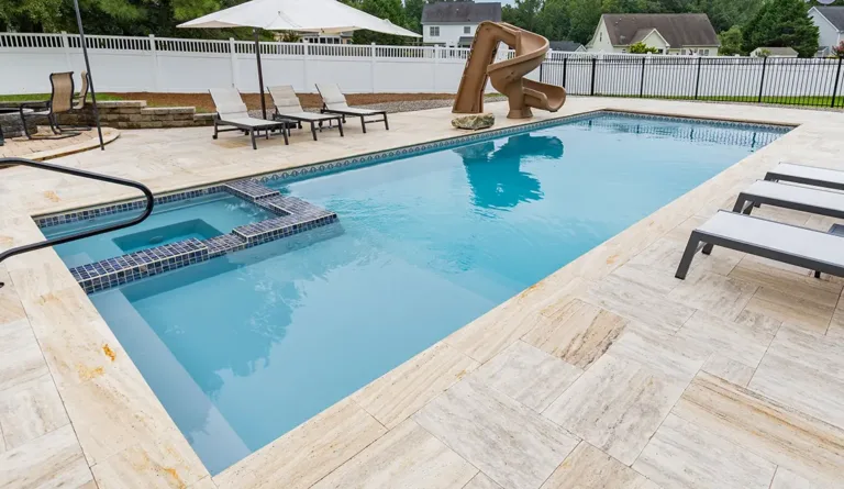 Leisure Pools Icon fiberglass pool in Graphite Grey with integrated splash deck and open swim area