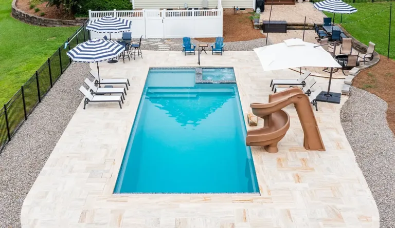 The Icon 40 fiberglass pool overhead view showing full shape with splash deck and built-in spa in Graphite Grey