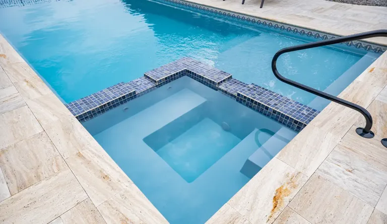 The Icon fiberglass pool built-in spa and entry steps detail in Graphite Grey