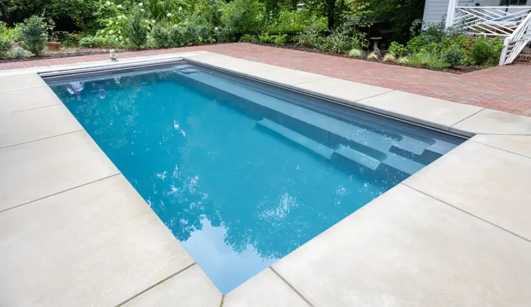 The Reflection fiberglass pool entry steps and full length bench seat detail in Graphite Grey