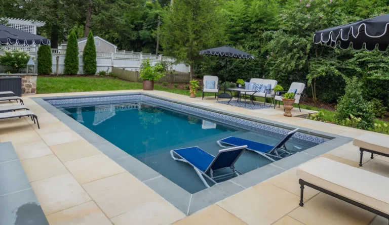 The Summit 30 fiberglass pool in Graphite Grey with landscaped backyard surrounding