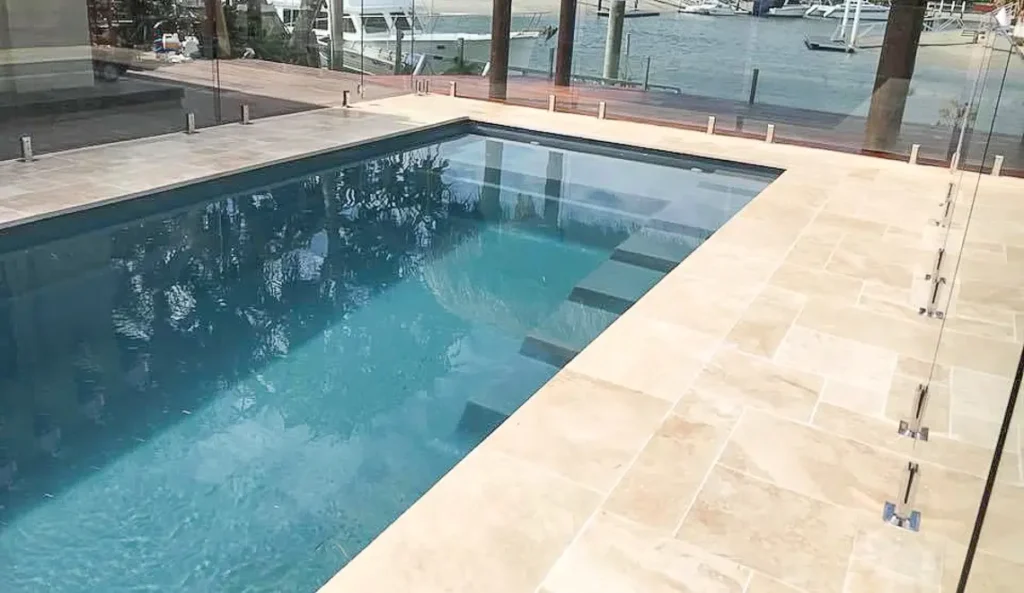 The Elite fiberglass pool high waterline and coping detail in Silver Grey waterfront installation
