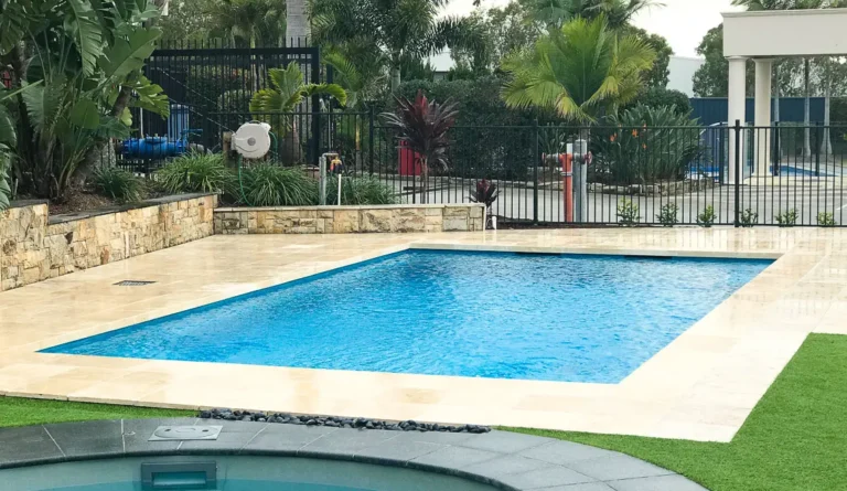 The Elite inground fiberglass pool with tropical backyard landscaping