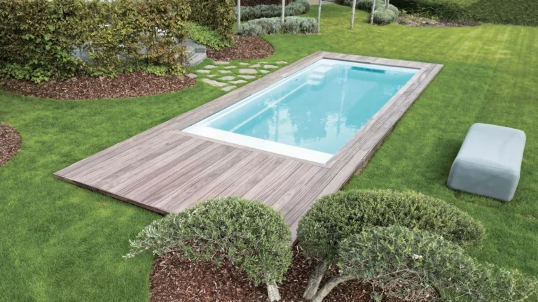 Leisure Pools Encore compact fiberglass pool installed with timber deck surround and auto cover