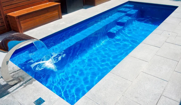 Leisure Pools Esprit fiberglass pool full length bench seat and swim channel