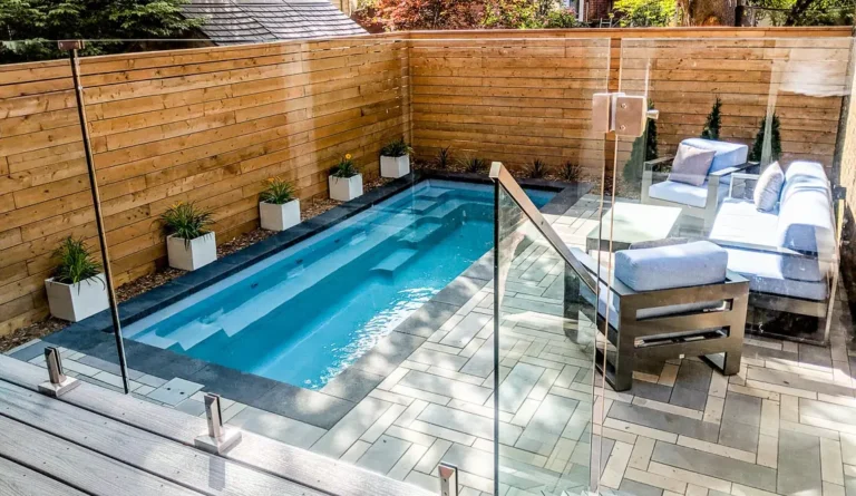 The Esprit narrow fiberglass pool with glass panel fence and entry steps detail
