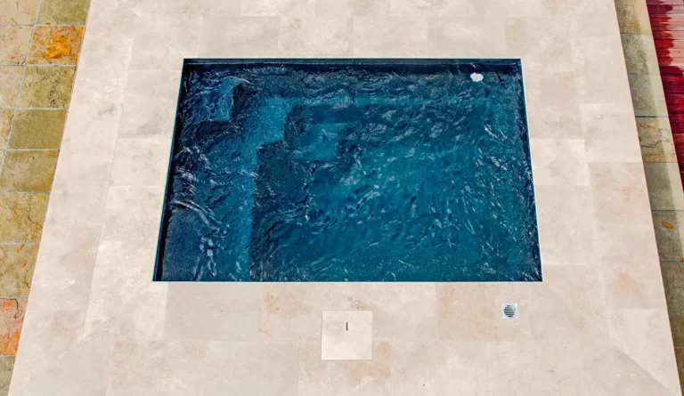 The Fiji Plunge compact fiberglass pool with stone patio surround overhead view