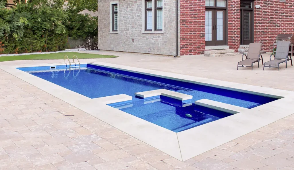 The Limitless fiberglass pool swim out bench and integrated splash deck detail