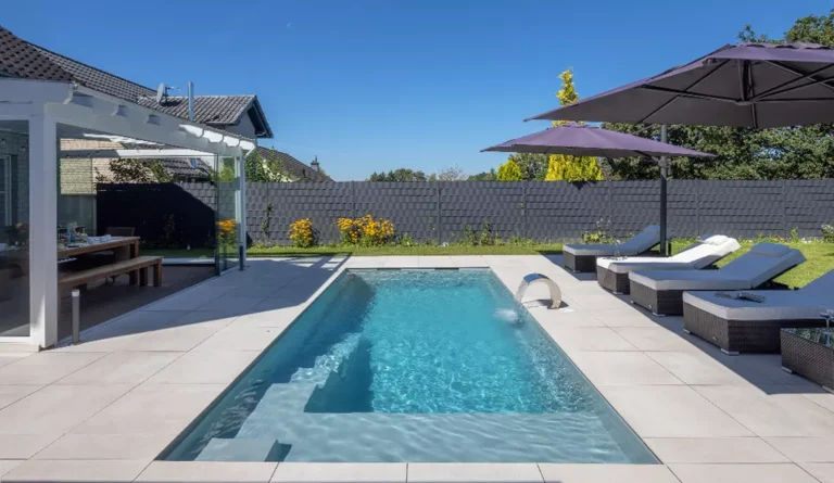 The Precision European-style fiberglass pool installed with contemporary backyard design