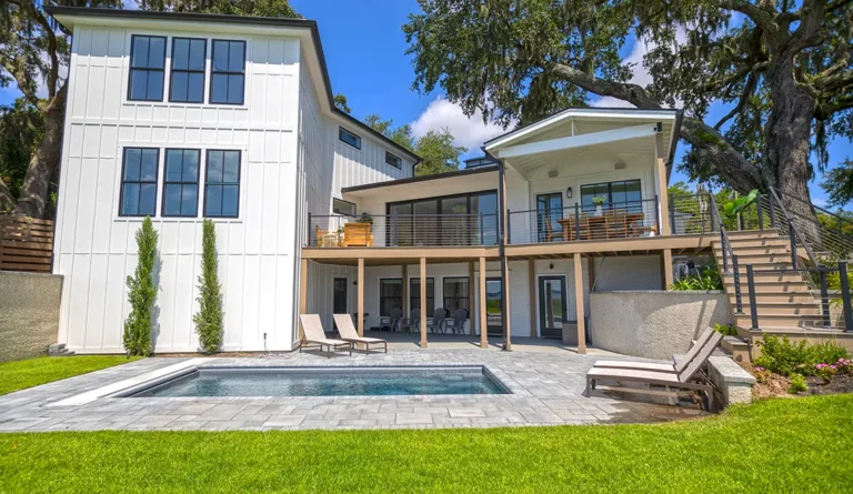 The Harmony fiberglass pool in Graphite Grey installed alongside white contemporary home