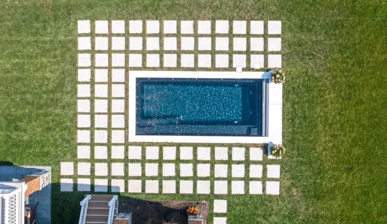 The Harmony compact fiberglass pool aerial view showing full rectangular shape in Ebony Blue