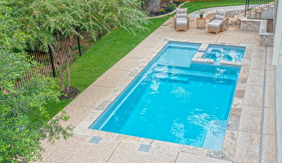 Leisure Pools Limitless fiberglass pool aerial view showing full shape with stepping stone path in Silver Grey