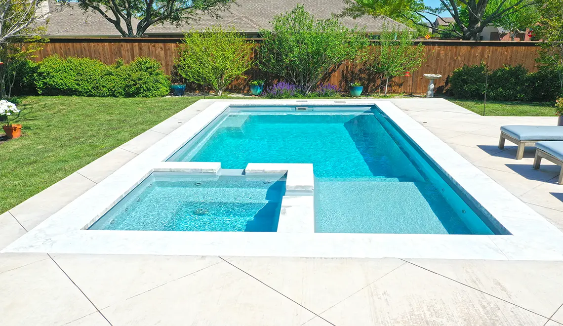 The Limitless fiberglass pool built-in spa and swim out bench in Silver Grey