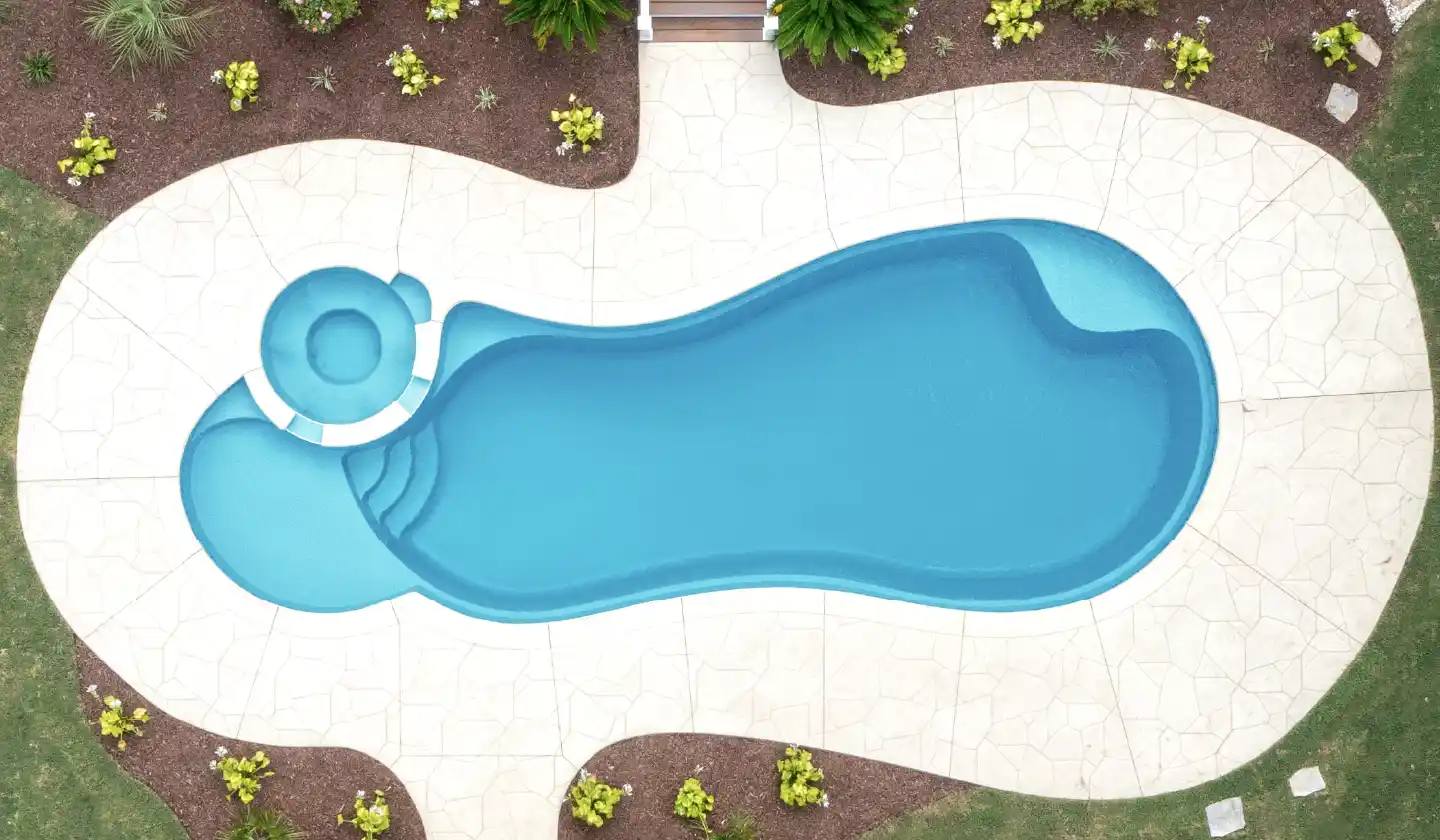 Overhead view showing The Allure™ in Crystal Blue, with an integrated circular spa beside the shallow lounging shelf.