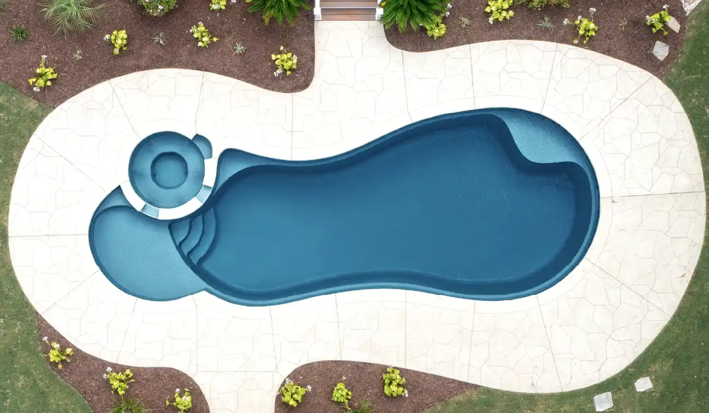The Allure™ shown in Ebony Blue, featuring a round spillover spa, curved entry steps and open swimming area.