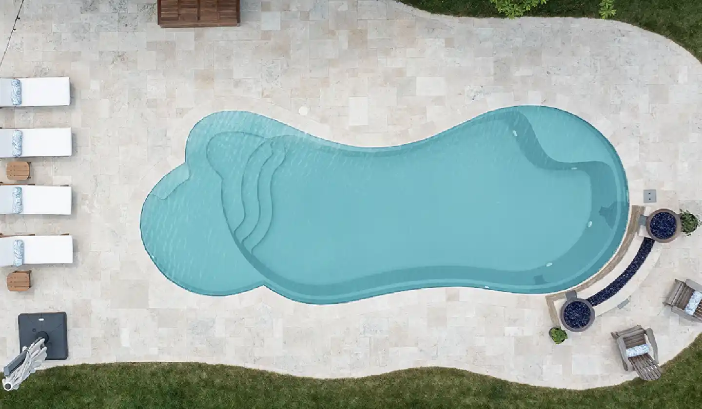 Overhead view showing The Eclipse™ in Diamond Sand, with a curved swim corridor bordered by a pale paved patio.