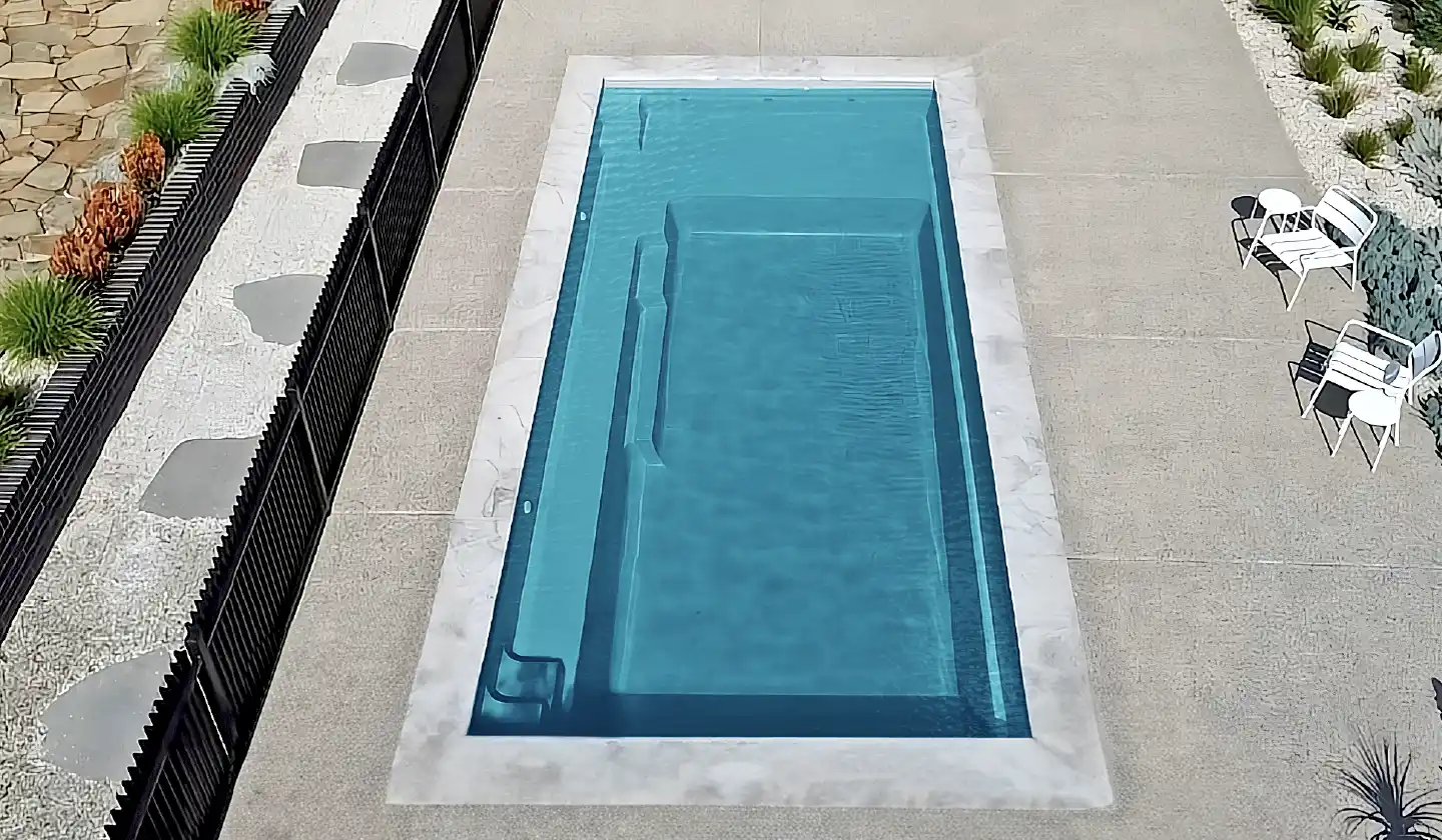 Elevated view of The Elite™ in Aquamarine, showing a rectangular swim area, broad splash deck and submerged seating.