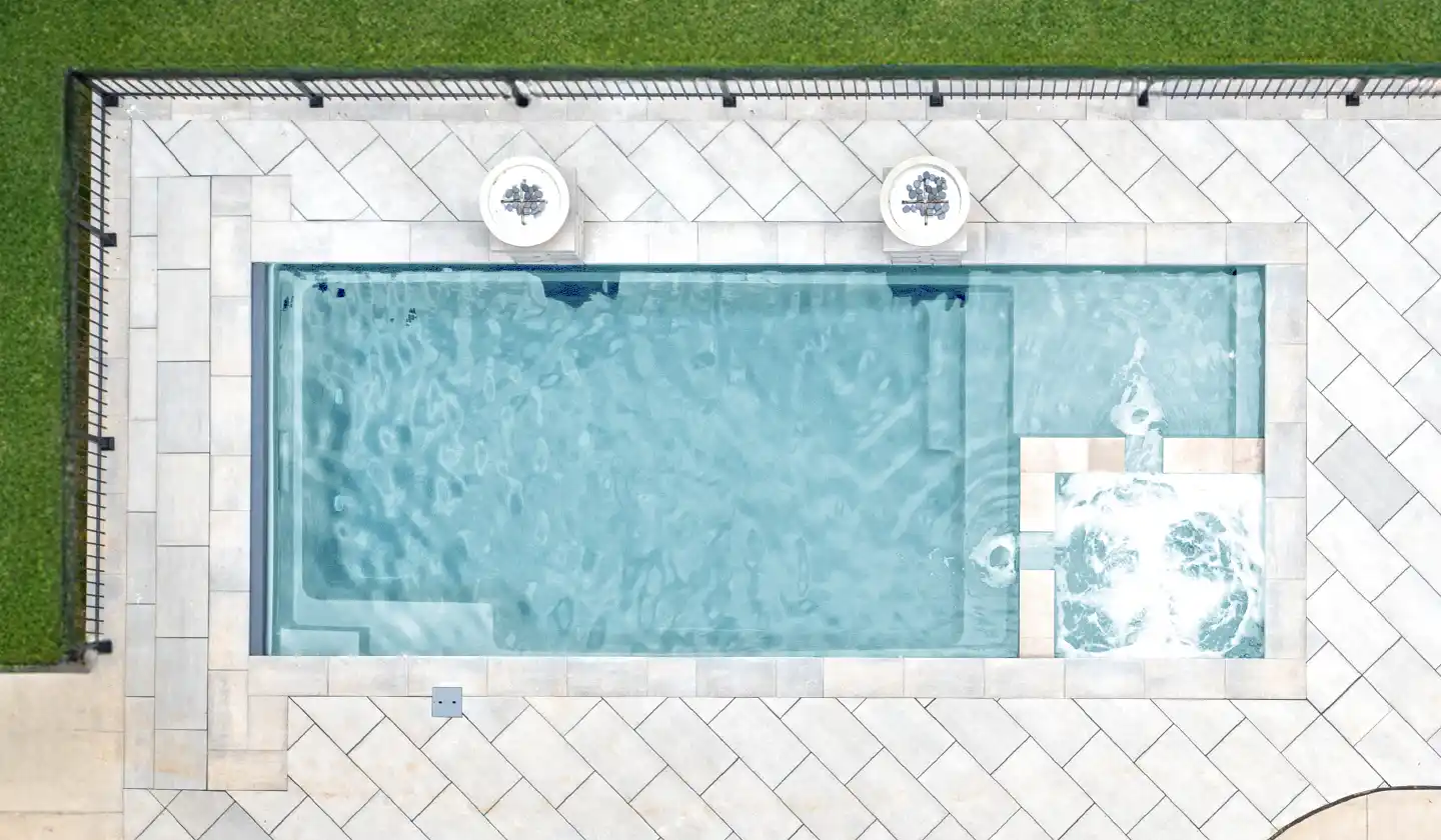 Overhead view showing The Limitless™ in Diamond Sand, with an open swim channel and spa grouped within a rectangular layout.