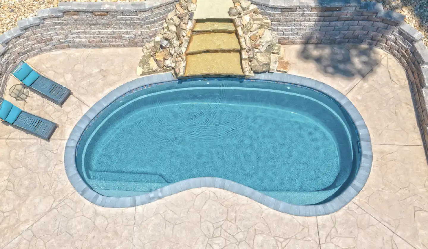 Elevated view showing The Tuscany™ in Silver Grey, with an open swimming space within a softly rounded kidney outline.